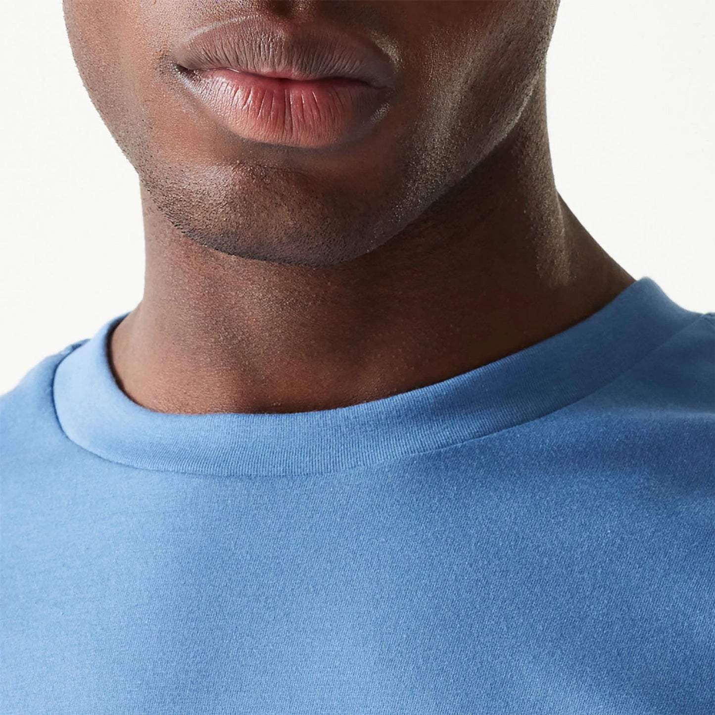 The Male model is wearing New Era Essential Blue Oversized T-Shirt 6