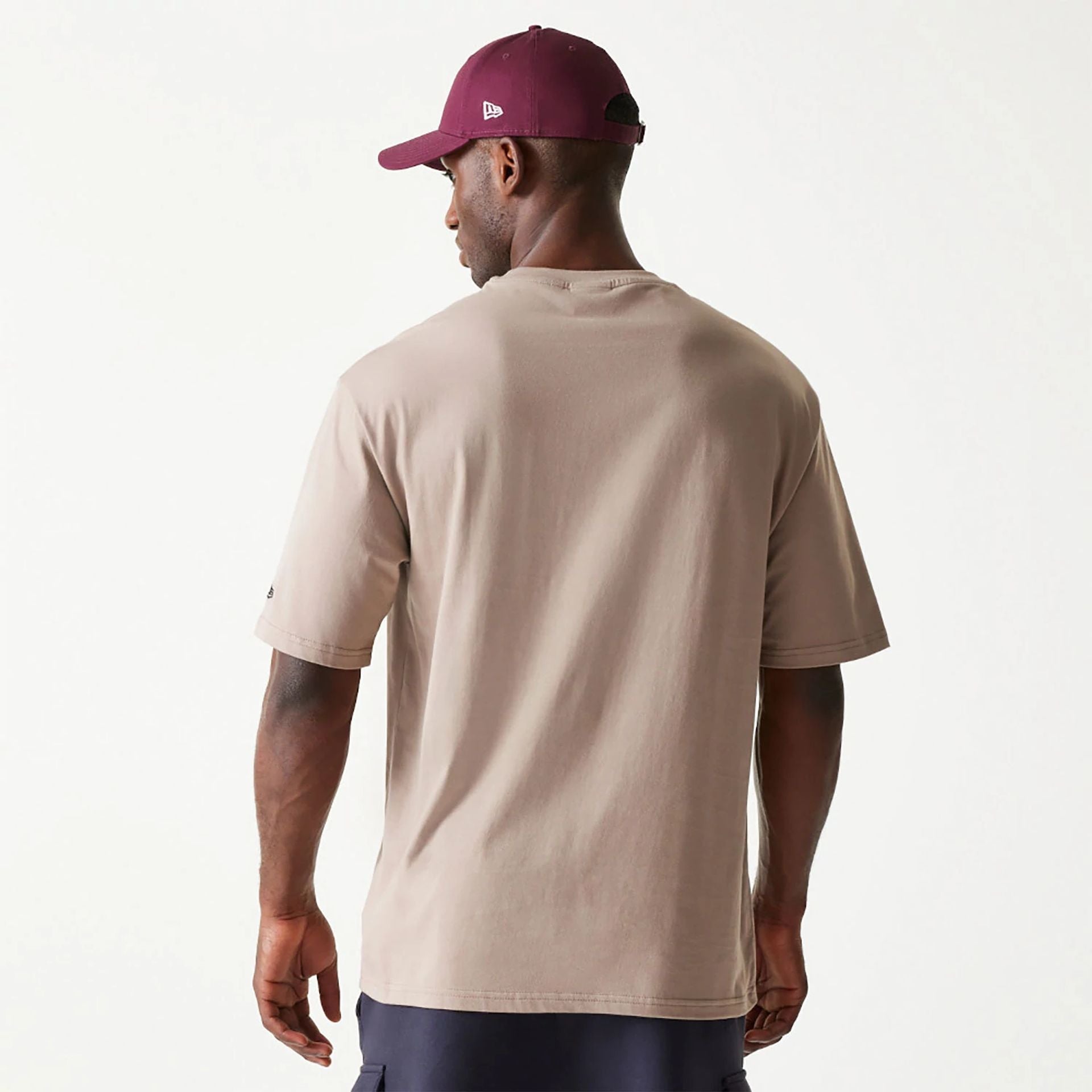 The Male model is wearing New Era Essential Pastel Brown Oversized T-Shirt 2