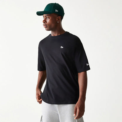 The Male model is wearing New Era Essential Black Oversized T-Shirt 1