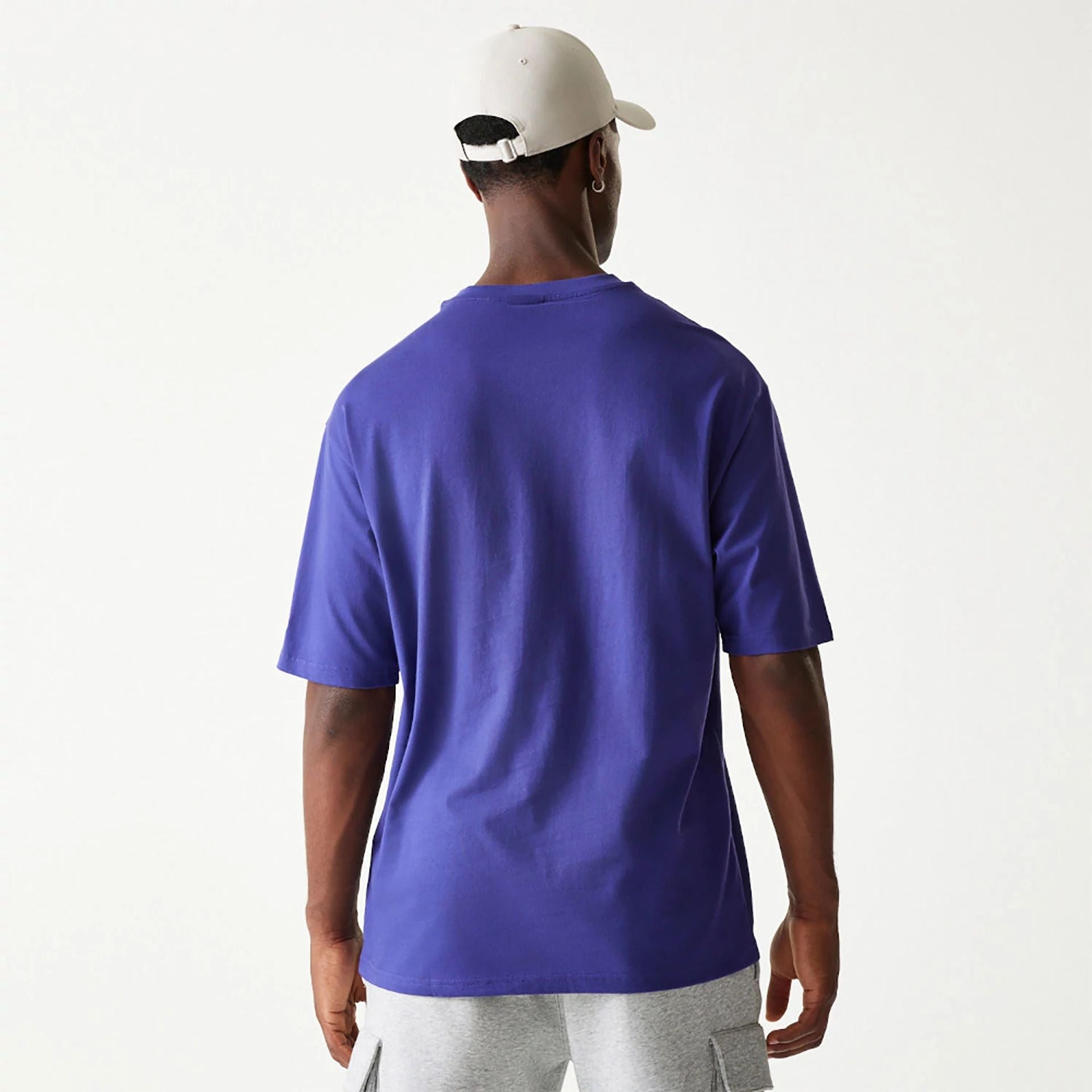 The Male model is wearing New Era Essential Dark Purple Oversized T-Shirt 2