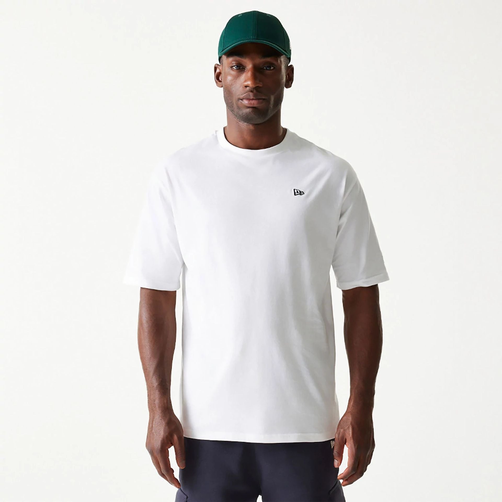 The Male model is wearing New Era Essential White Oversized T-Shirt 1