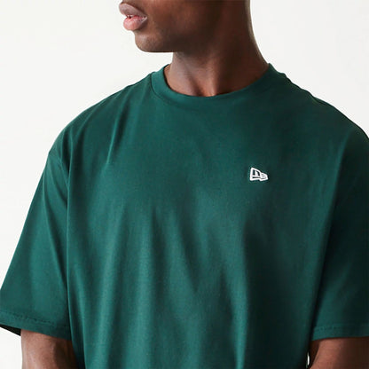 The Male model is wearing New Era Essential Dark Green Oversized T-Shirt 3