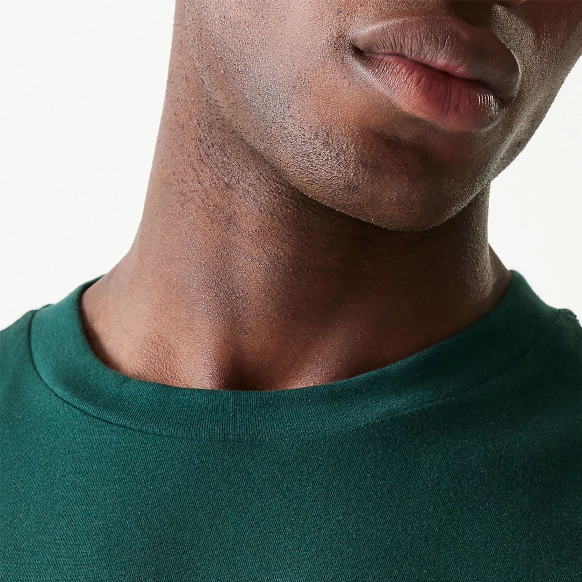 The Male model is wearing New Era Essential Dark Green Oversized T-Shirt 6