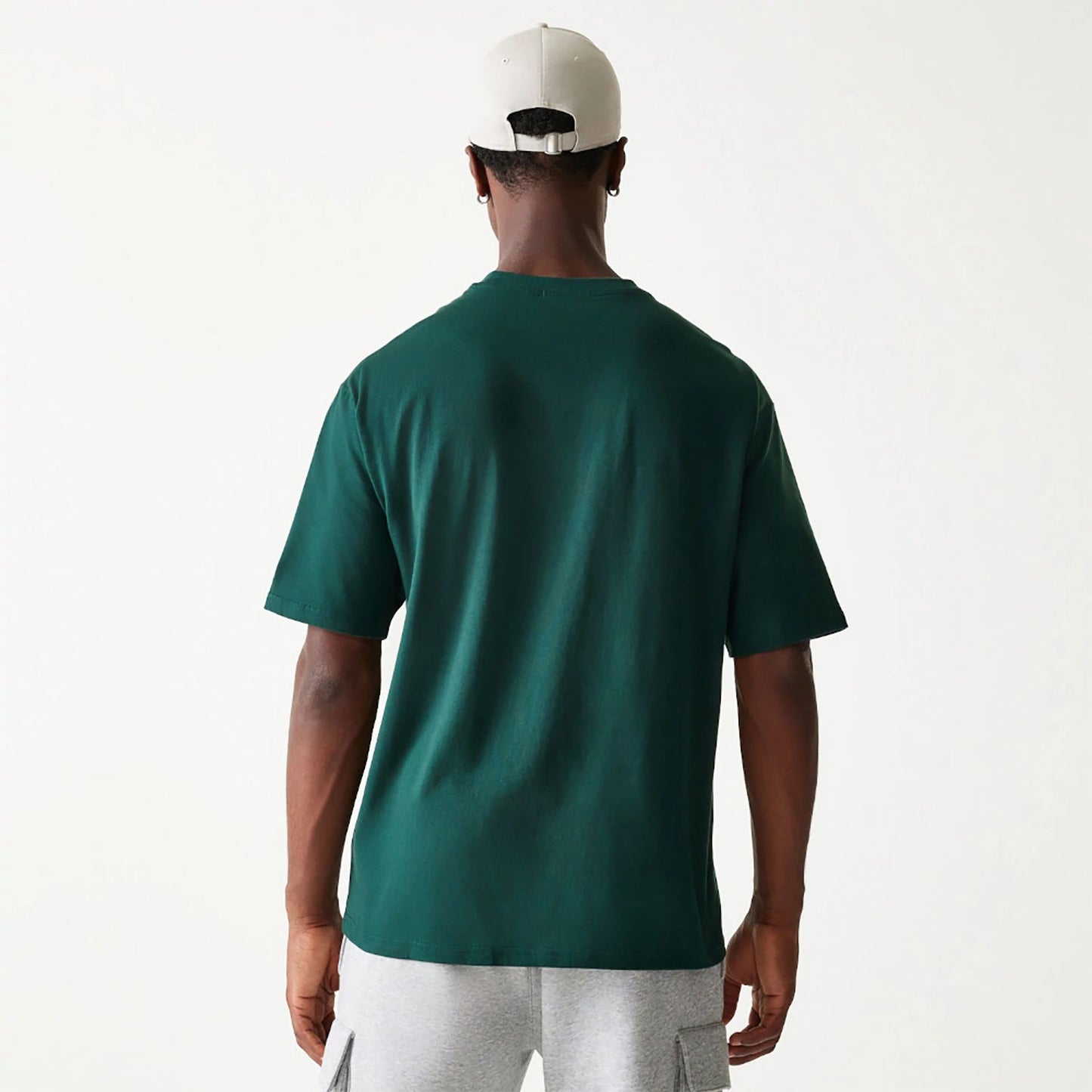 The Male model is wearing New Era Essential Dark Green Oversized T-Shirt 2