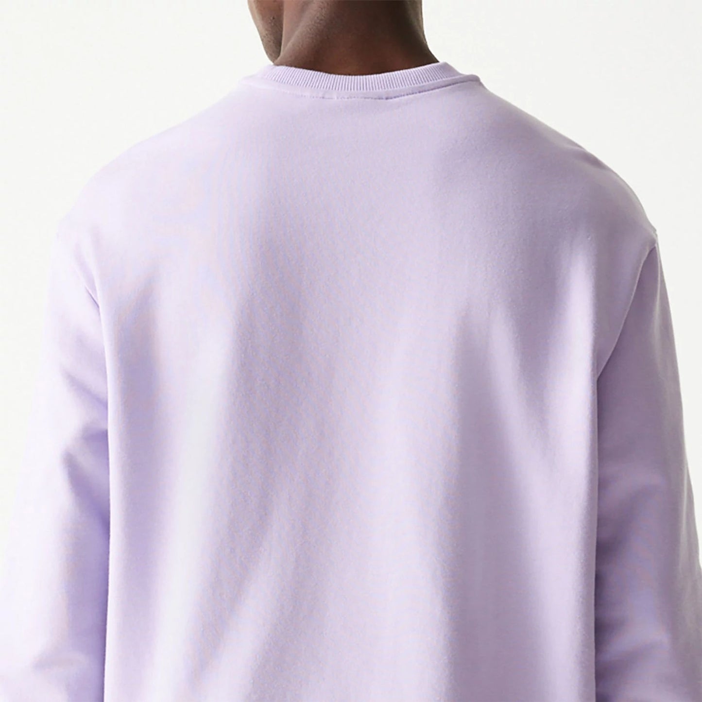 The Male model is wearing New Era Essential Pastel Purple Crewneck Sweater 7