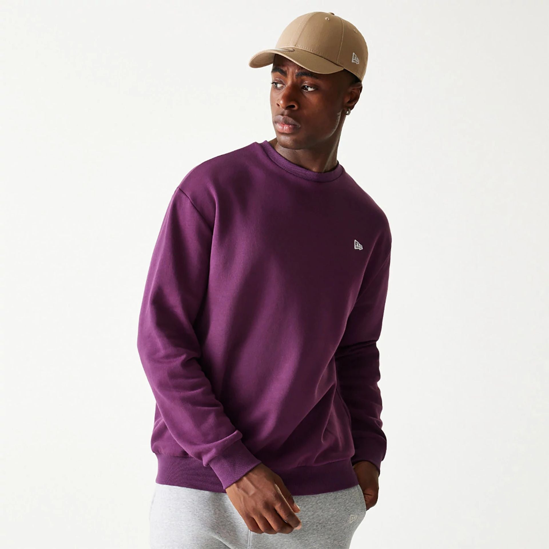 The Male model is wearing New Era Essential Brushed Fleece Dark Purple Crewneck Sweater 1