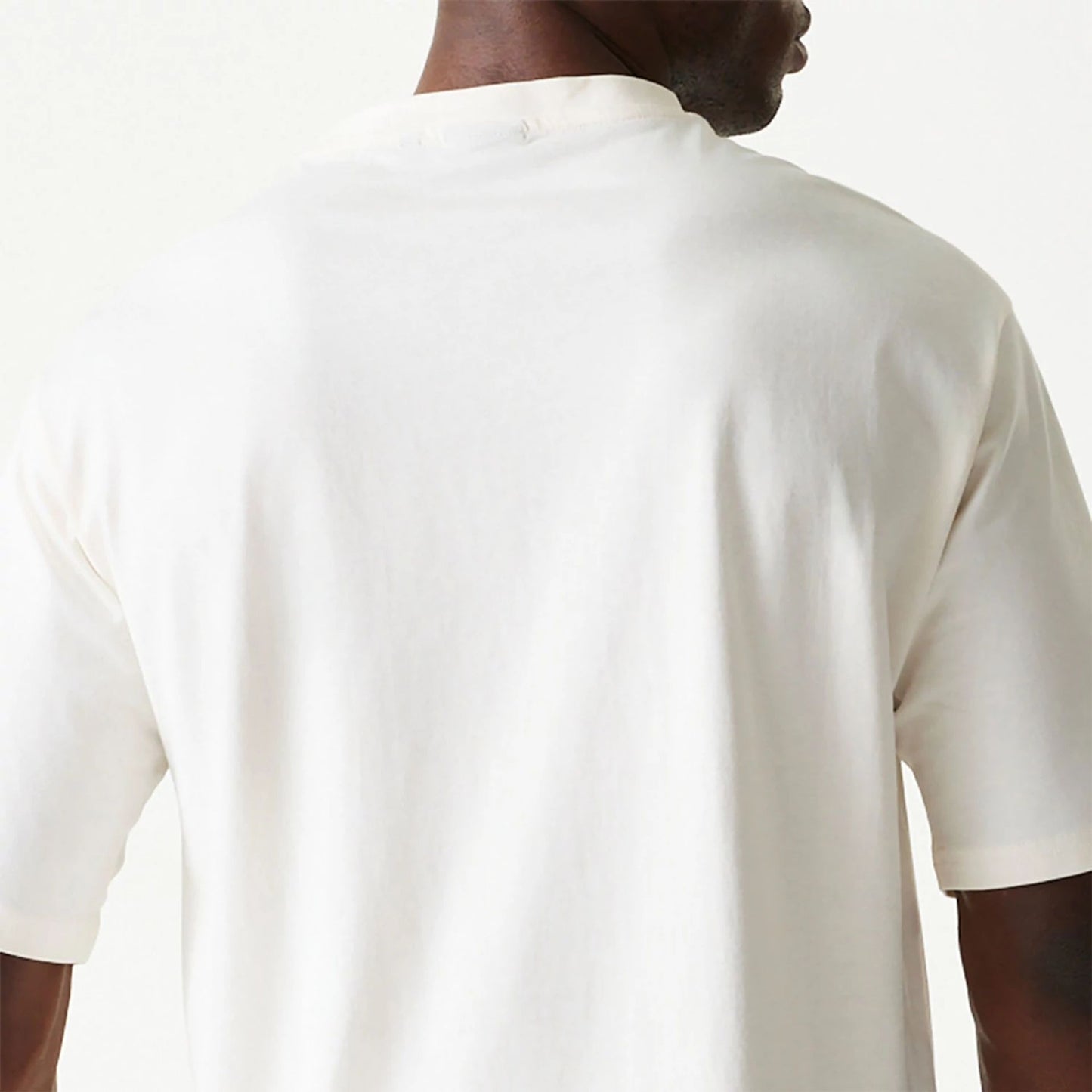 The Male model is wearing New Era Essential Cream Oversized T-Shirt 7