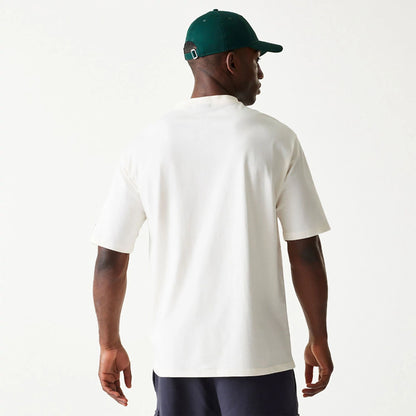 The Male model is wearing New Era Essential Cream Oversized T-Shirt 2