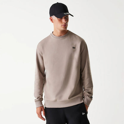 The Male model is wearing New Era Essential Brushed Fleece Pastel Brown Crewneck Sweater 1