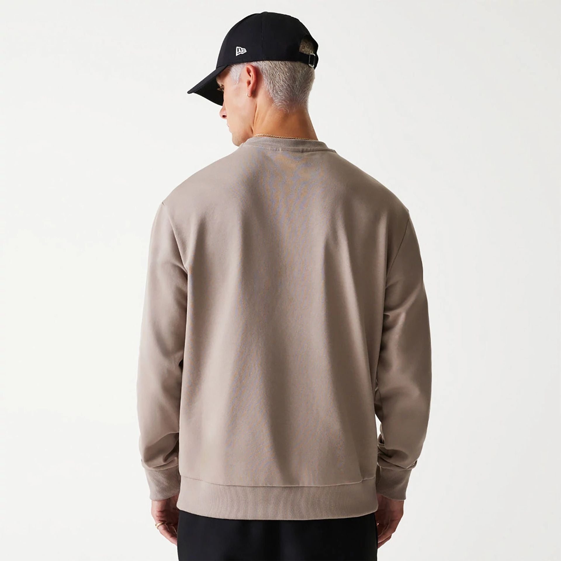 The Male model is wearing New Era Essential Brushed Fleece Pastel Brown Crewneck Sweater 2