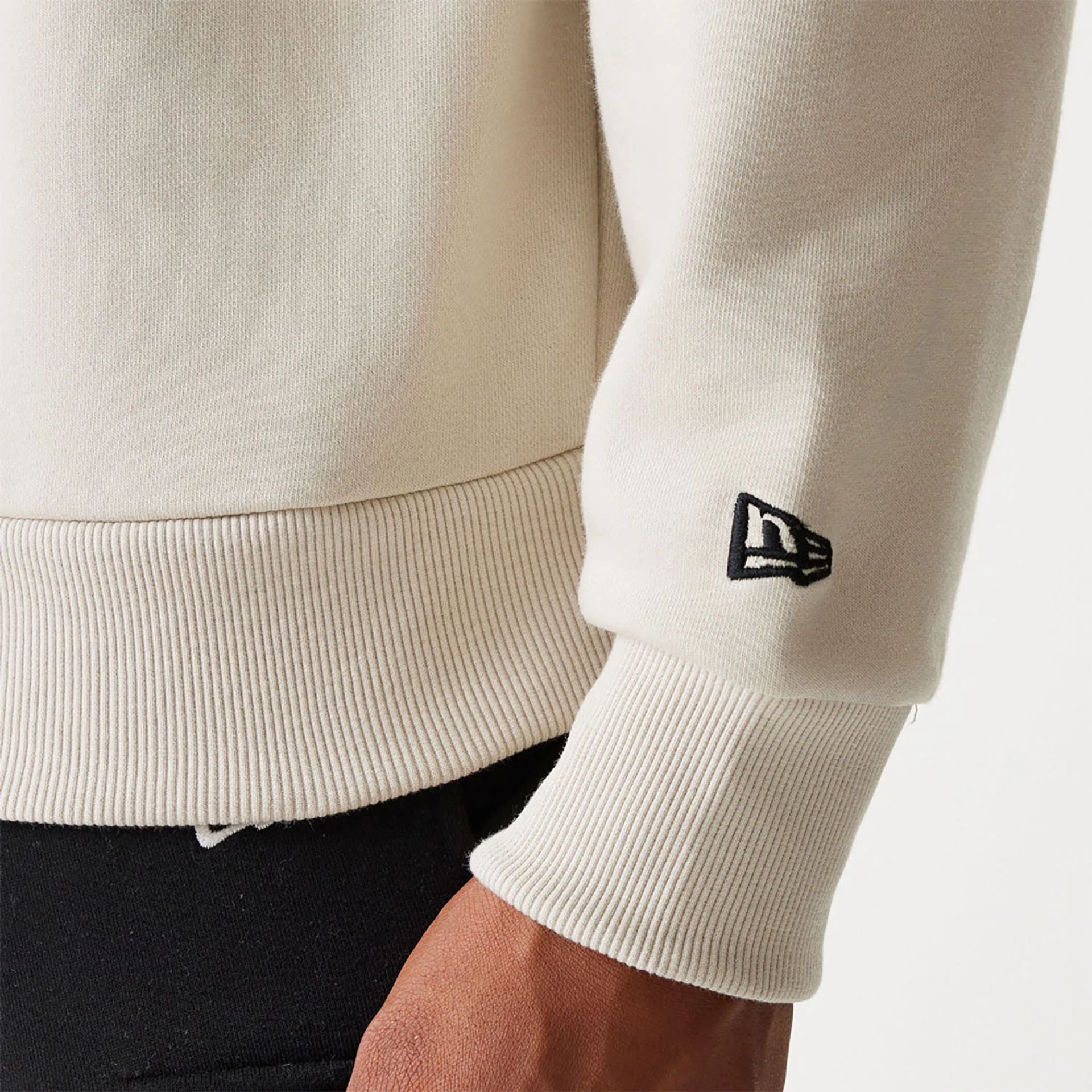 The Male model is wearing New Era Essential Brushed Fleece Light Beige Crewneck Sweater 5