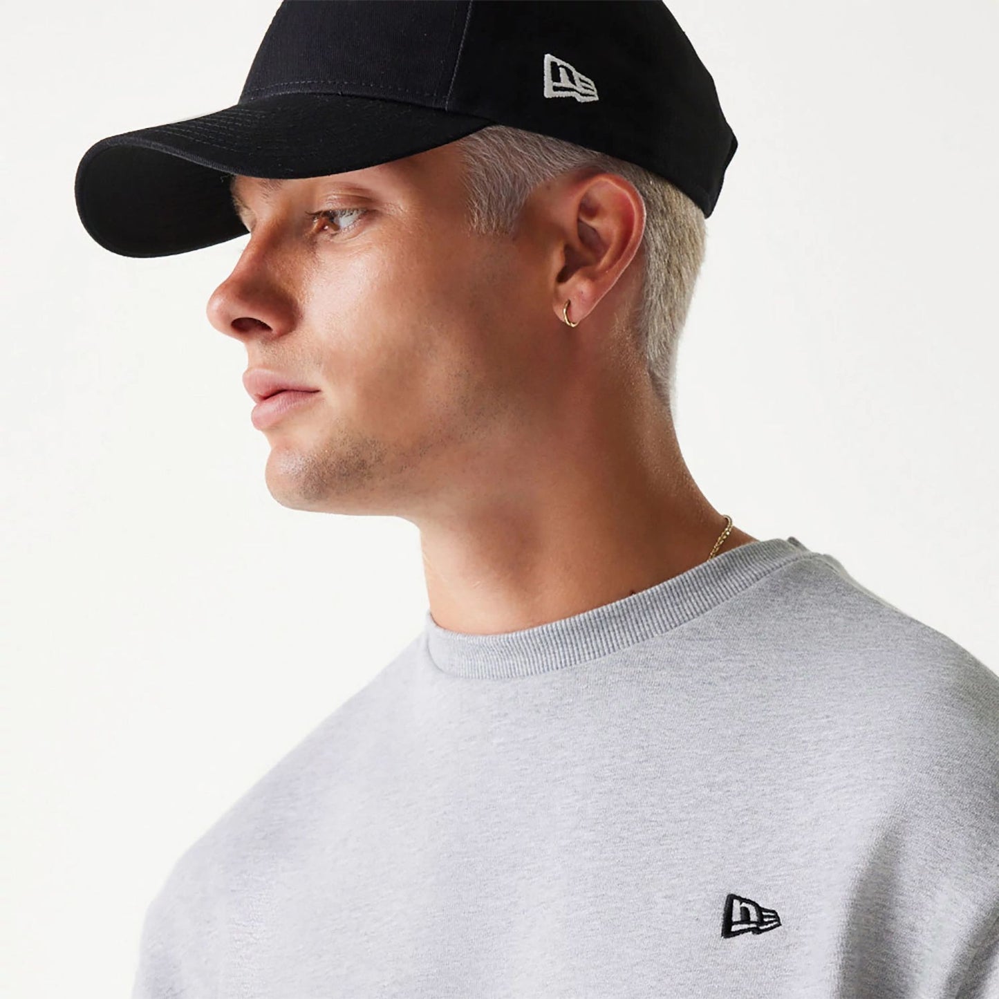 The Male model is wearing New Era Essential Brushed Fleece Grey Crewneck Sweater 4