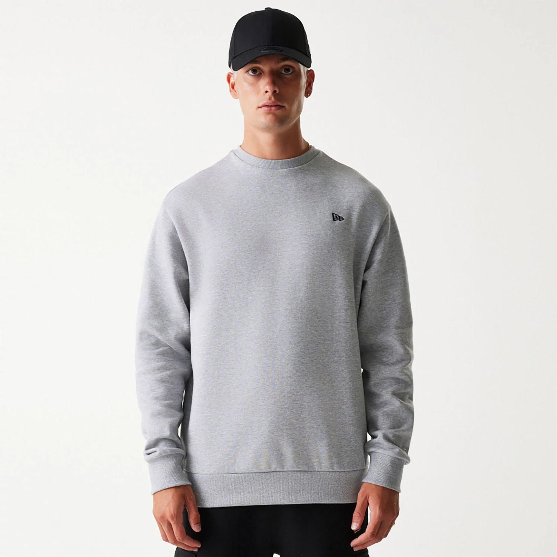 The Male model is wearing New Era Essential Brushed Fleece Grey Crewneck Sweater 1