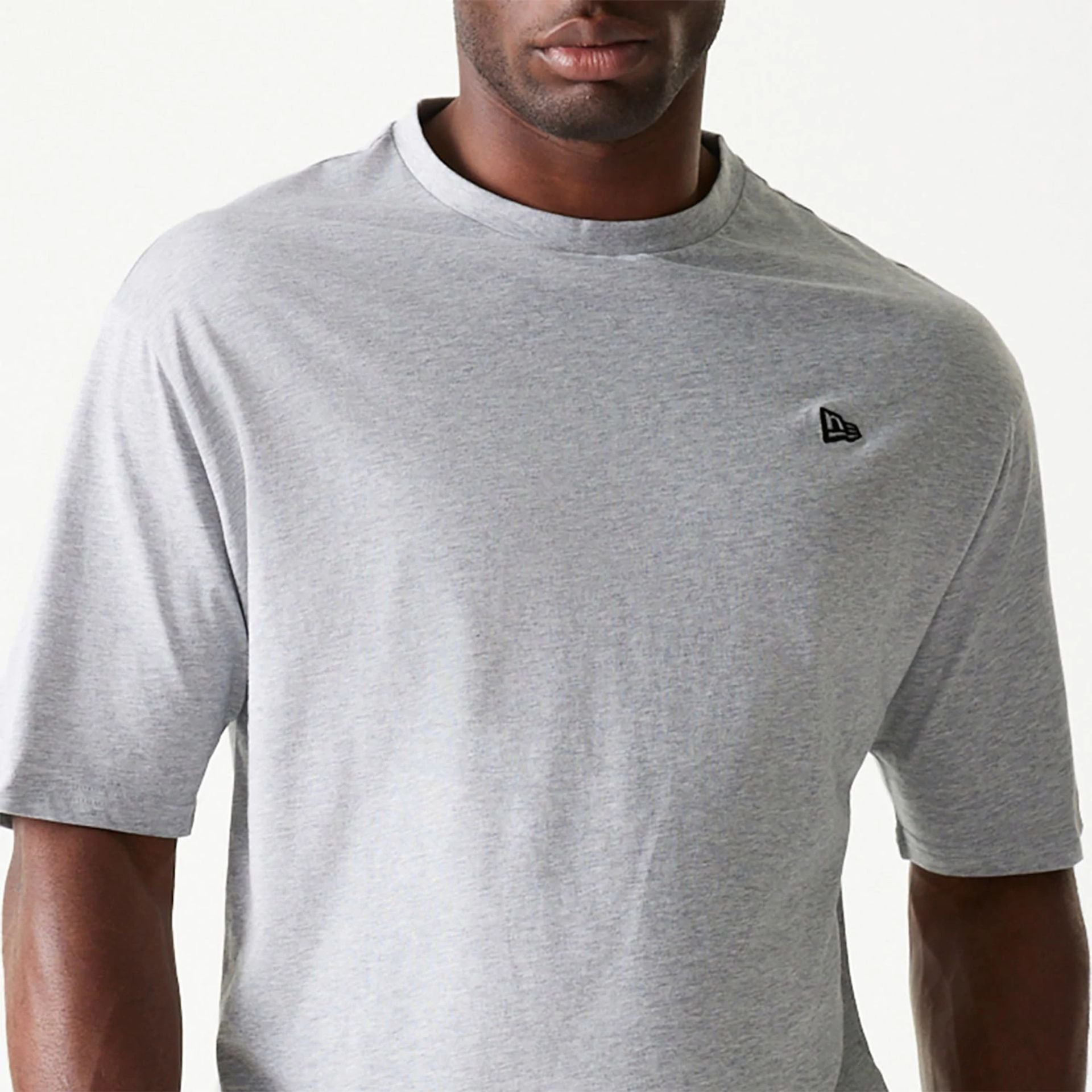 The Male model is wearing New Era Essential Grey Oversized T-Shirt 3