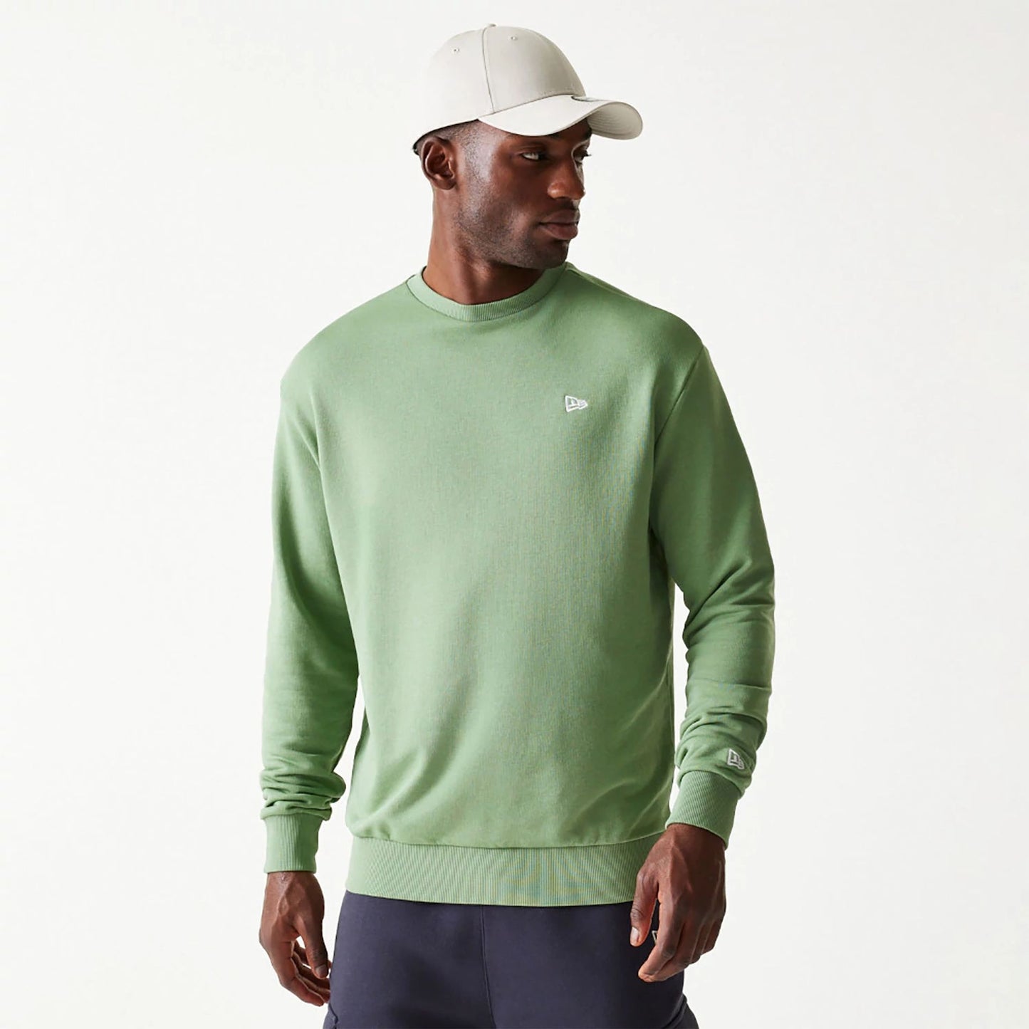 The Male model is wearing New Era Essential Pastel Green Oversized Crewneck Sweater 1