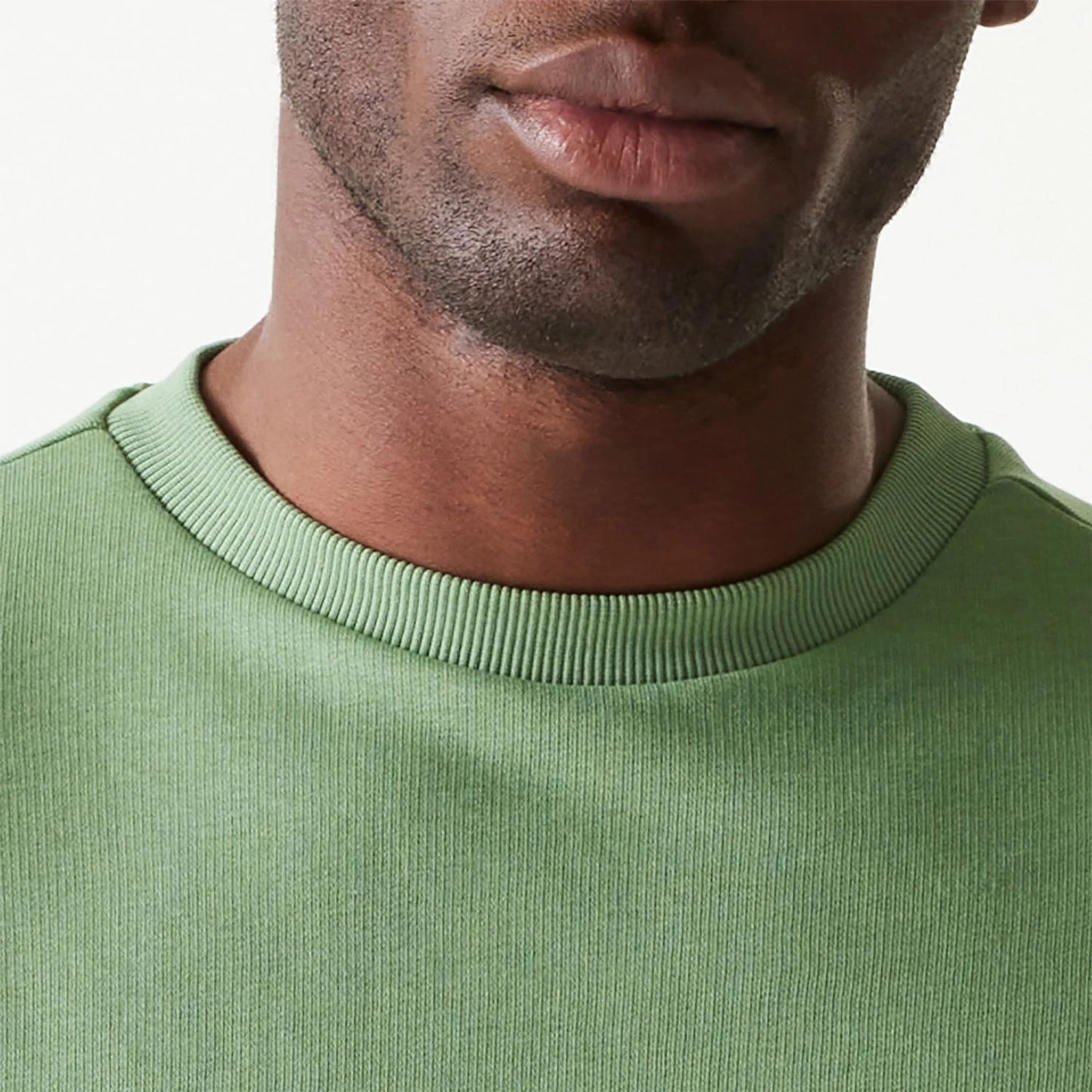 The Male model is wearing New Era Essential Pastel Green Oversized Crewneck Sweater 6