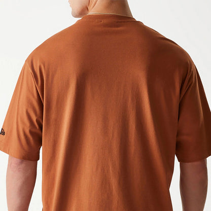 The Male model is wearing New Era Essential Brown Oversized T-Shirt 7