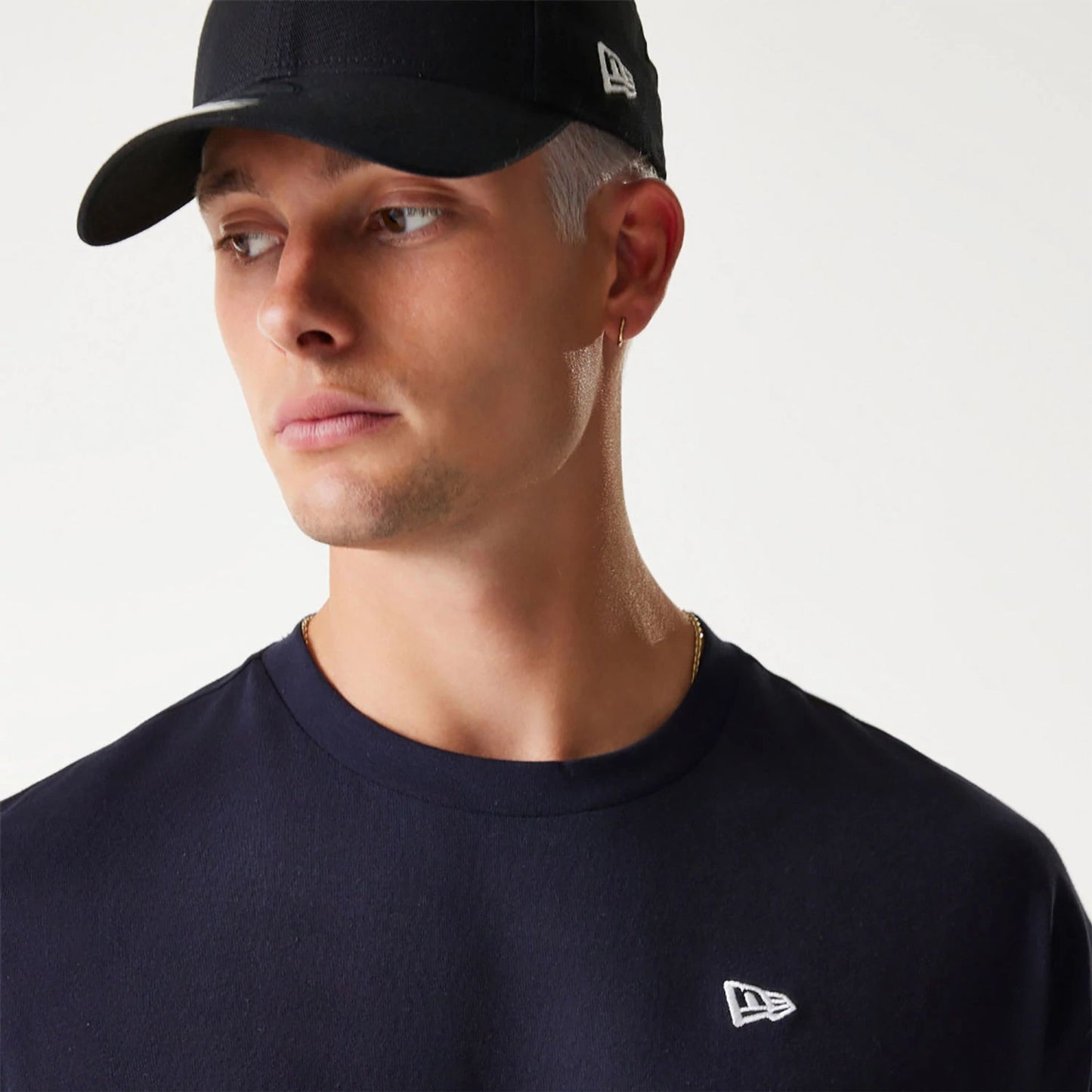 The Male model is wearing New Era Essential Navy Oversized T-Shirt 4