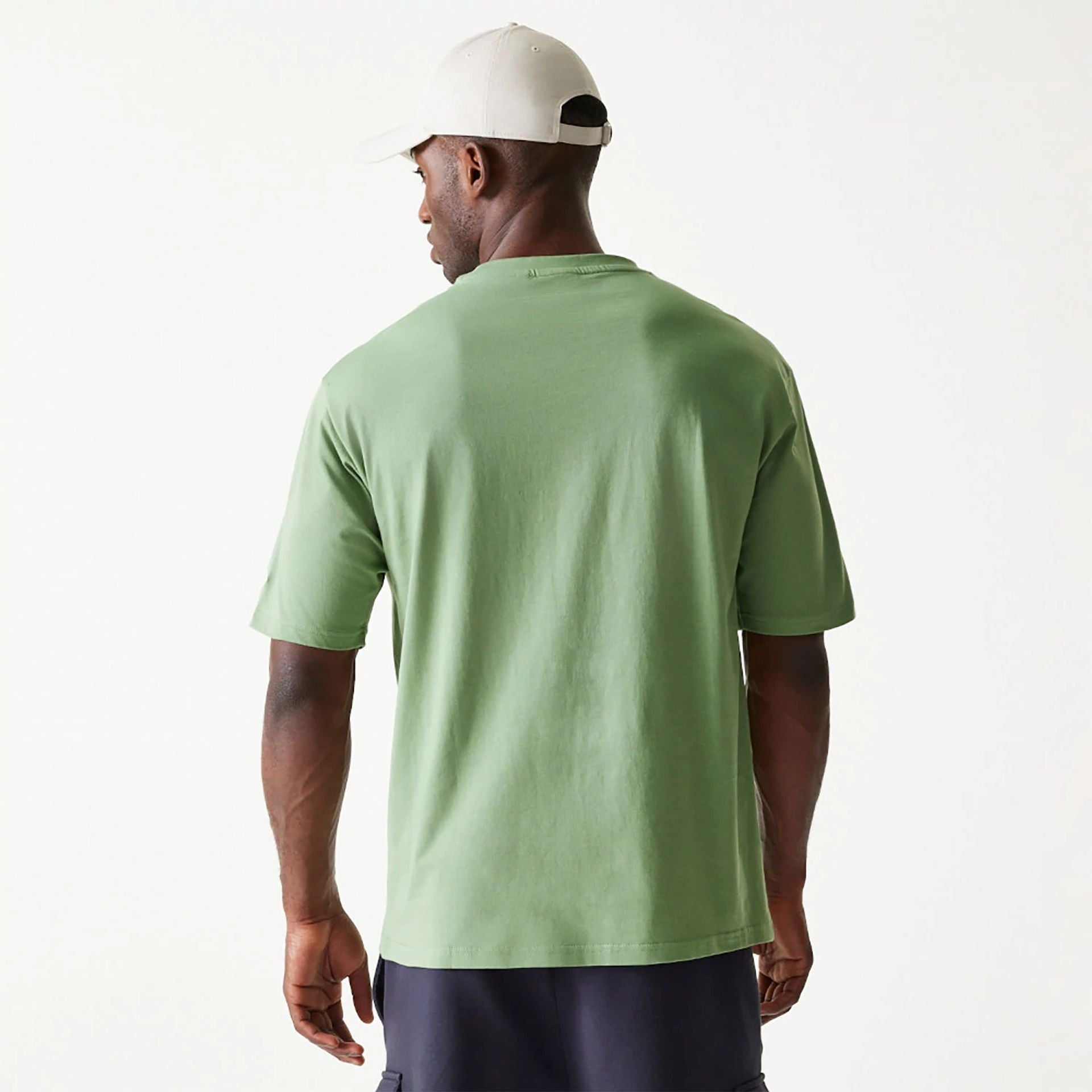 The Male model is wearing New Era Essential Green Oversized T-Shirt 2