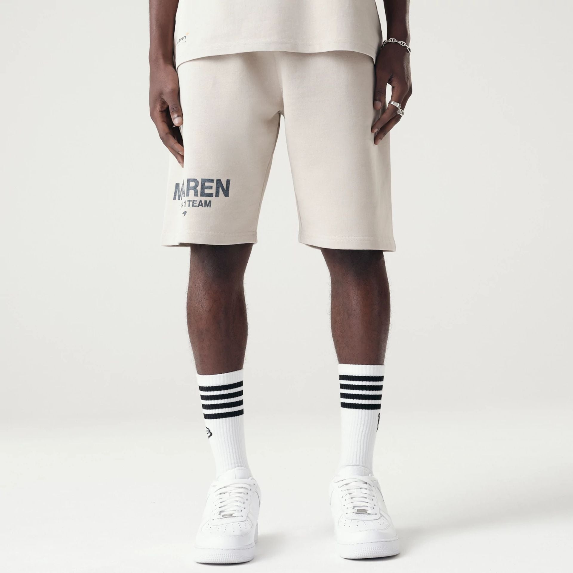 The Male model is wearing McLaren Racing Washed Pack Cream Oversized Shorts 1