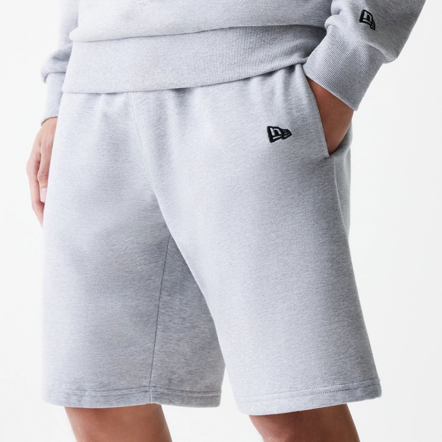 The Male model is wearing New Era Grey Oversized One Panel Shorts 3