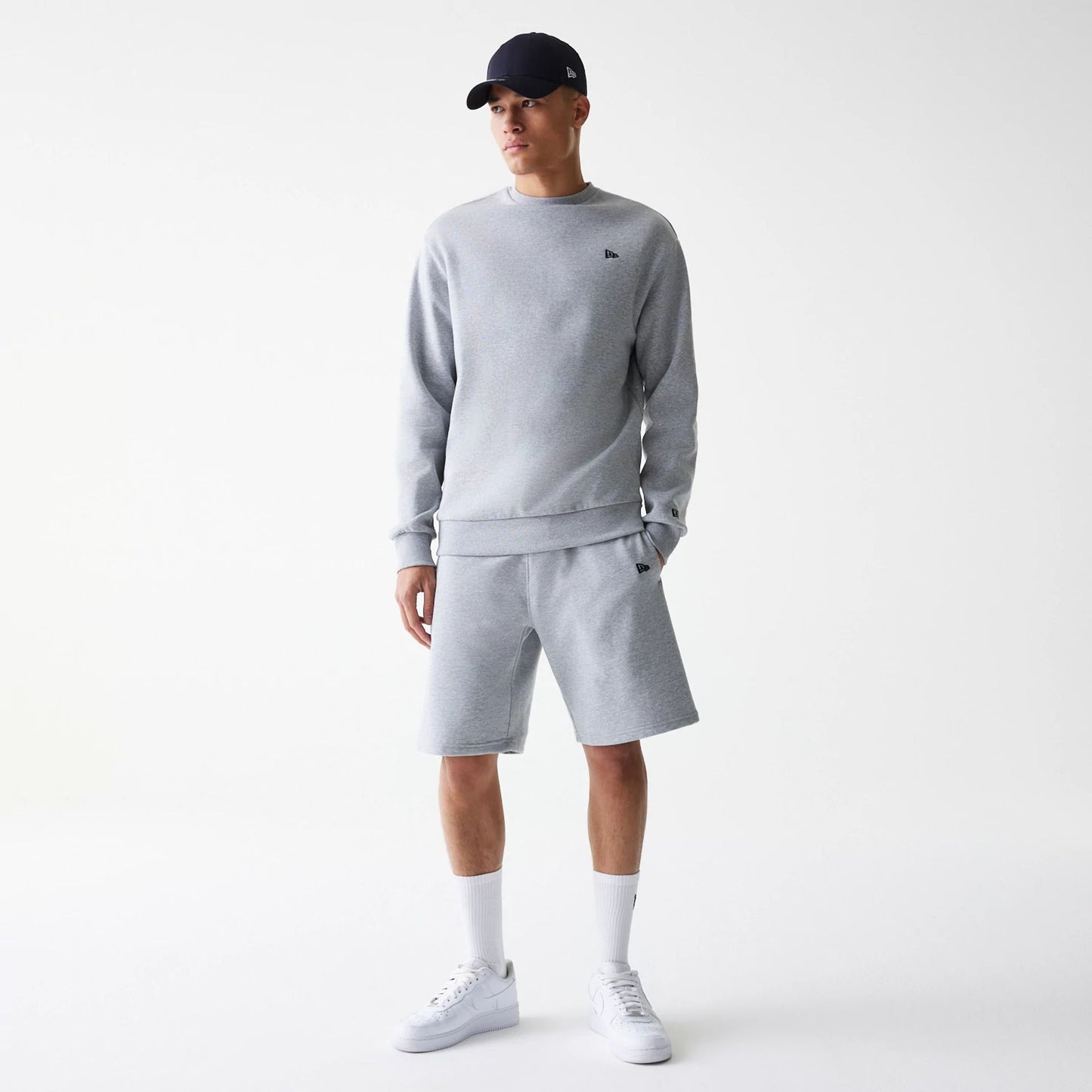 The Male model is wearing New Era Grey Oversized One Panel Shorts 8