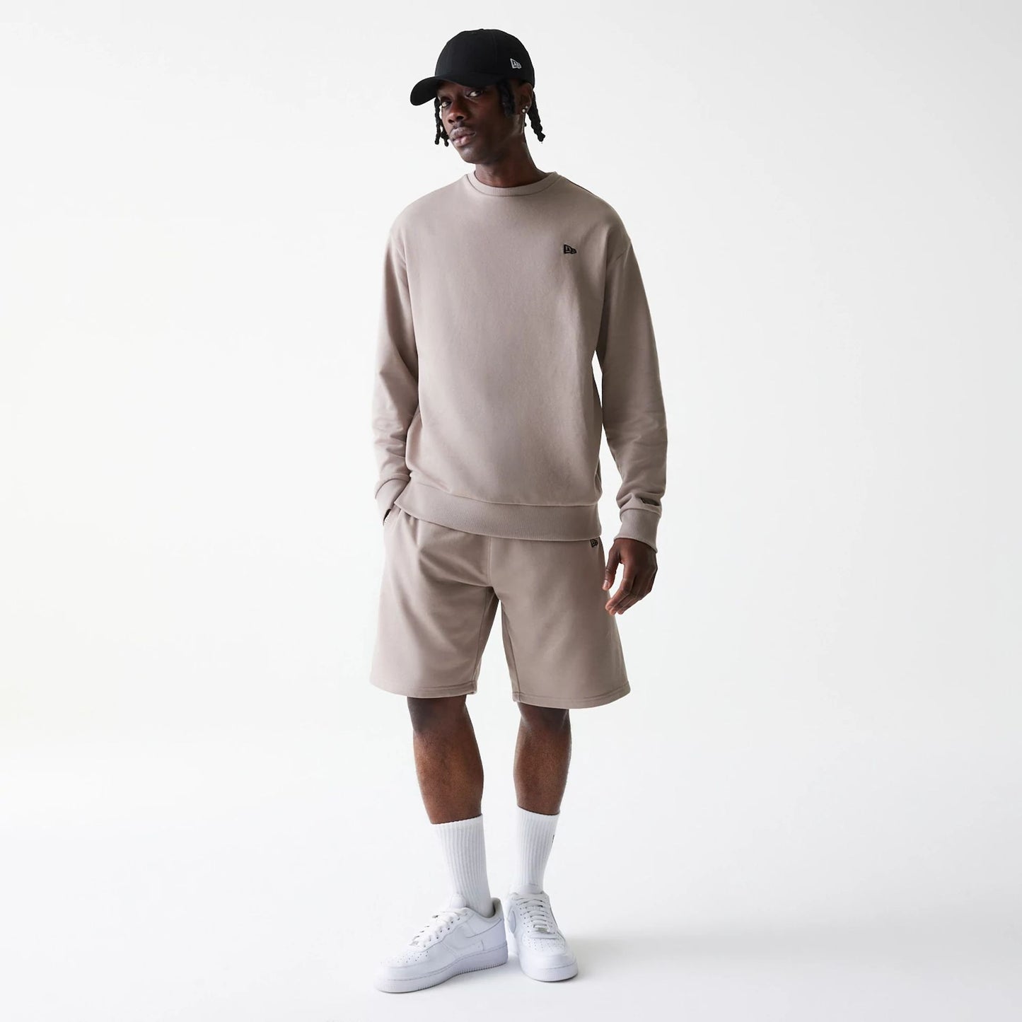 The Male model is wearing New Era Pastel Brown Oversized One Panel Shorts 8