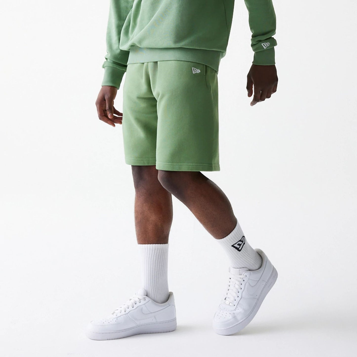 The Male model is wearing New Era Green Oversized One Panel Shorts 7