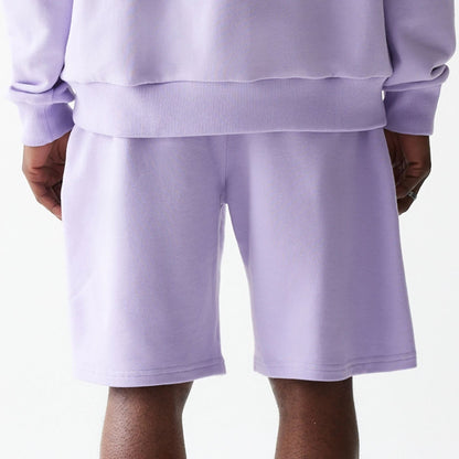 The Male model is wearing New Era Pastel Purple Oversized One Panel Shorts 6