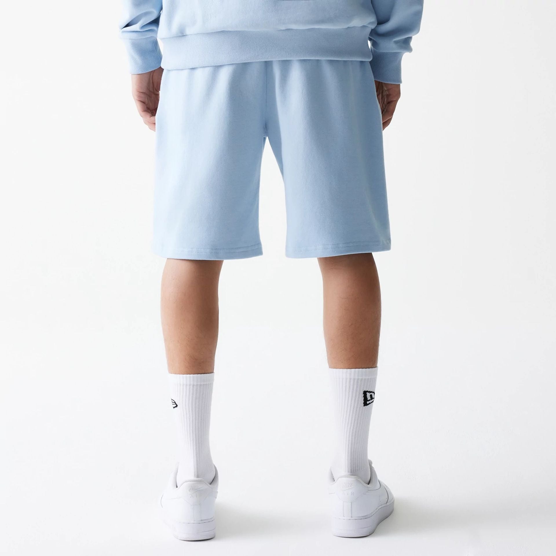 The Male model is wearing New Era Pastel Blue Oversized One Panel Shorts 2