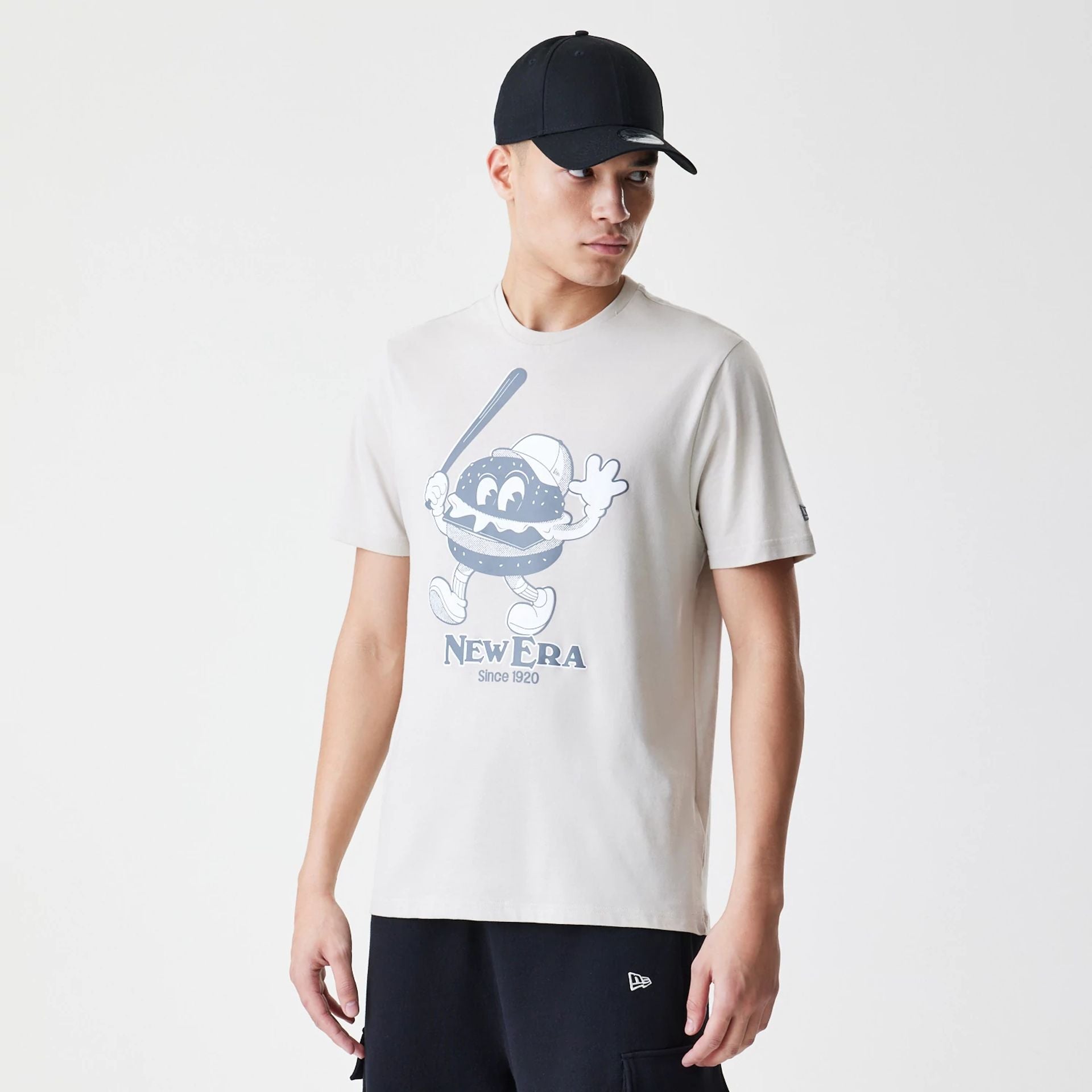 The Male model is wearing New Era Burger Graphic Cream T-Shirt 1