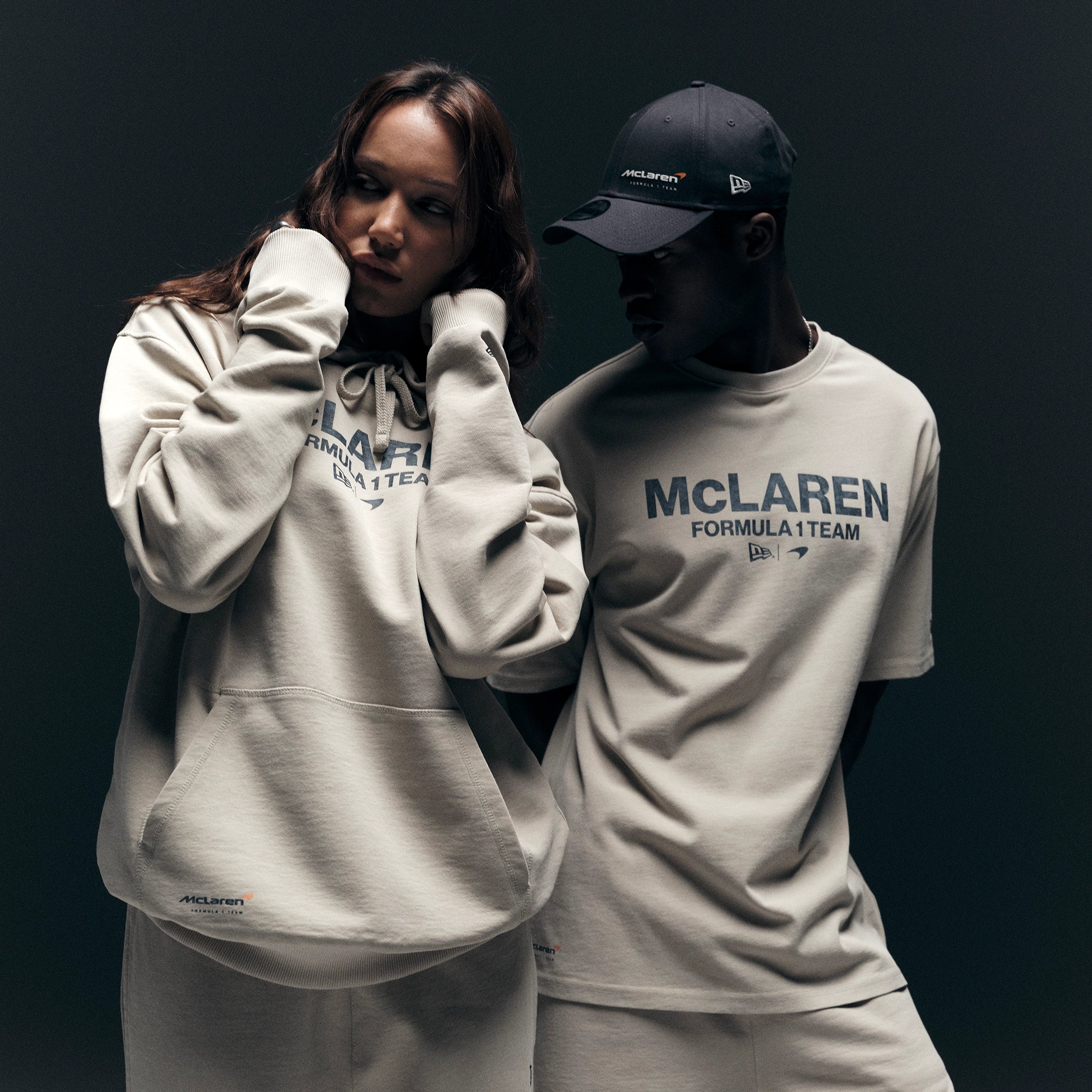 man and women wearing mclaren hoodie and top